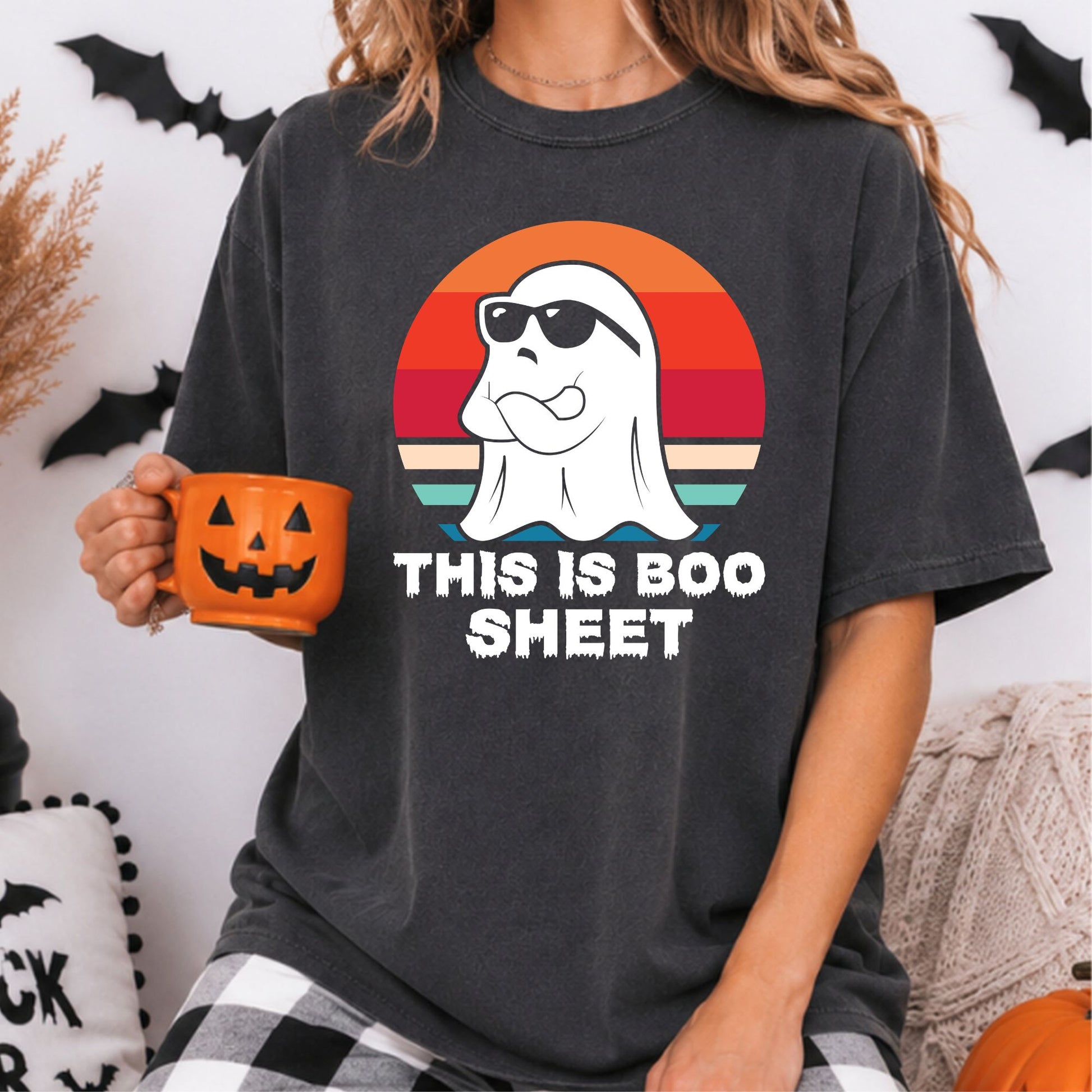 This Is Boo Sheet Halloween DTF transfer featuring a confident white sheet ghost wearing black sunglasses with folded arms, set against a colorful retro sunset design on a dark charcoal T-shirt mockup.