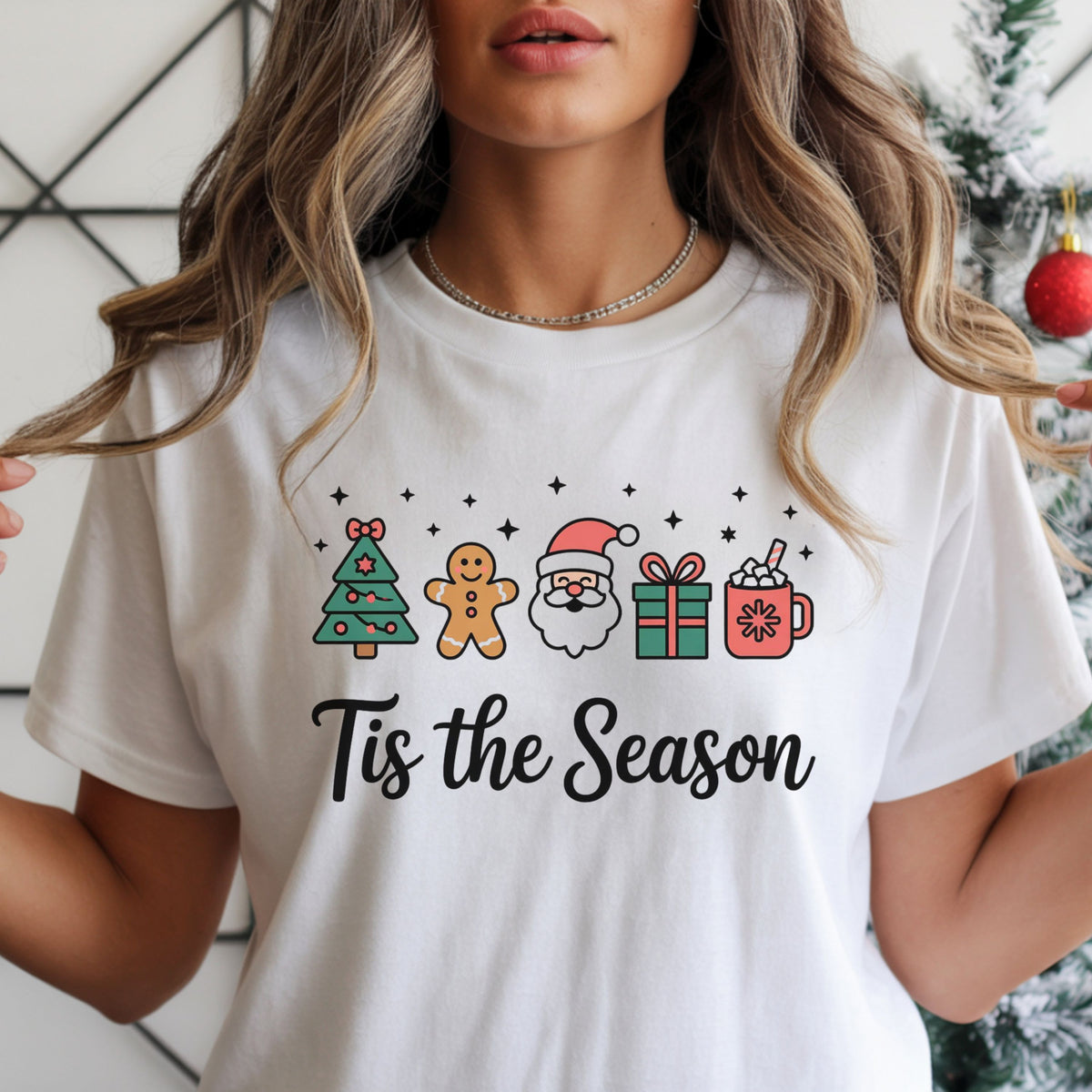 “Tis the Season” in black script beneath a green Christmas tree, gingerbread cookie, Santa face, wrapped gift and coral cocoa mug, with black stars.