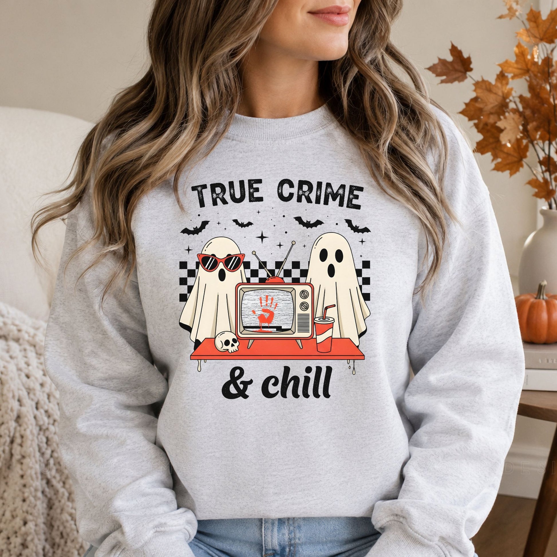 True Crime and Chill Halloween DTF transfer featuring two sheet ghosts watching a retro television with a red handprint on the screen, surrounded by bats, stars, a skull, soda cup and black-and-white checkerboard accents on a gray sweatshirt mockup.