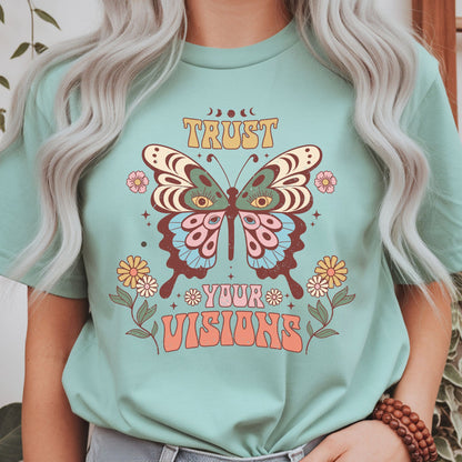 Boho butterfly graphic with floral accents, moon phases, and the inspirational quote "Trust Your Visions." A retro cottagecore inspired design for positive mindset, self growth, and spiritual aesthetic apparel.
