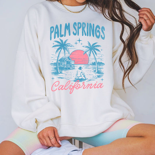 Vintage Palm Springs California graphic featuring retro palm trees, desert sunset, and vacation scenery. Perfect for California travel lovers, desert vacations, summer apparel, and retro graphic tees or hoodies.