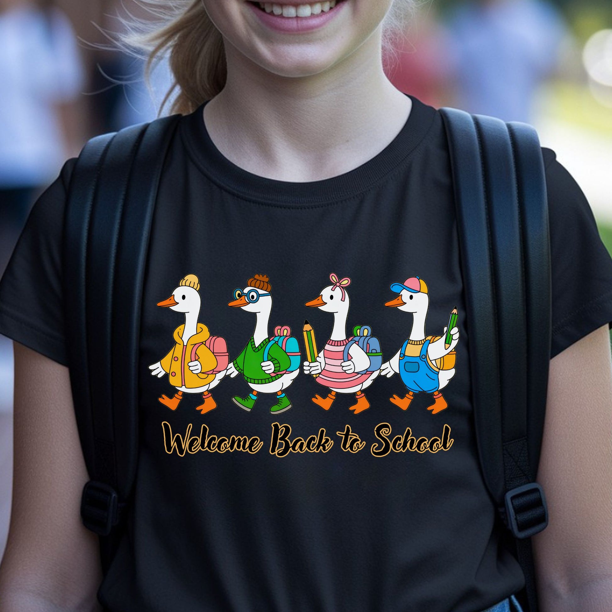 Welcome Back to School design featuring four cute geese wearing colorful school outfits, backpacks, sweaters, hats, and carrying pencils for kids shirts.